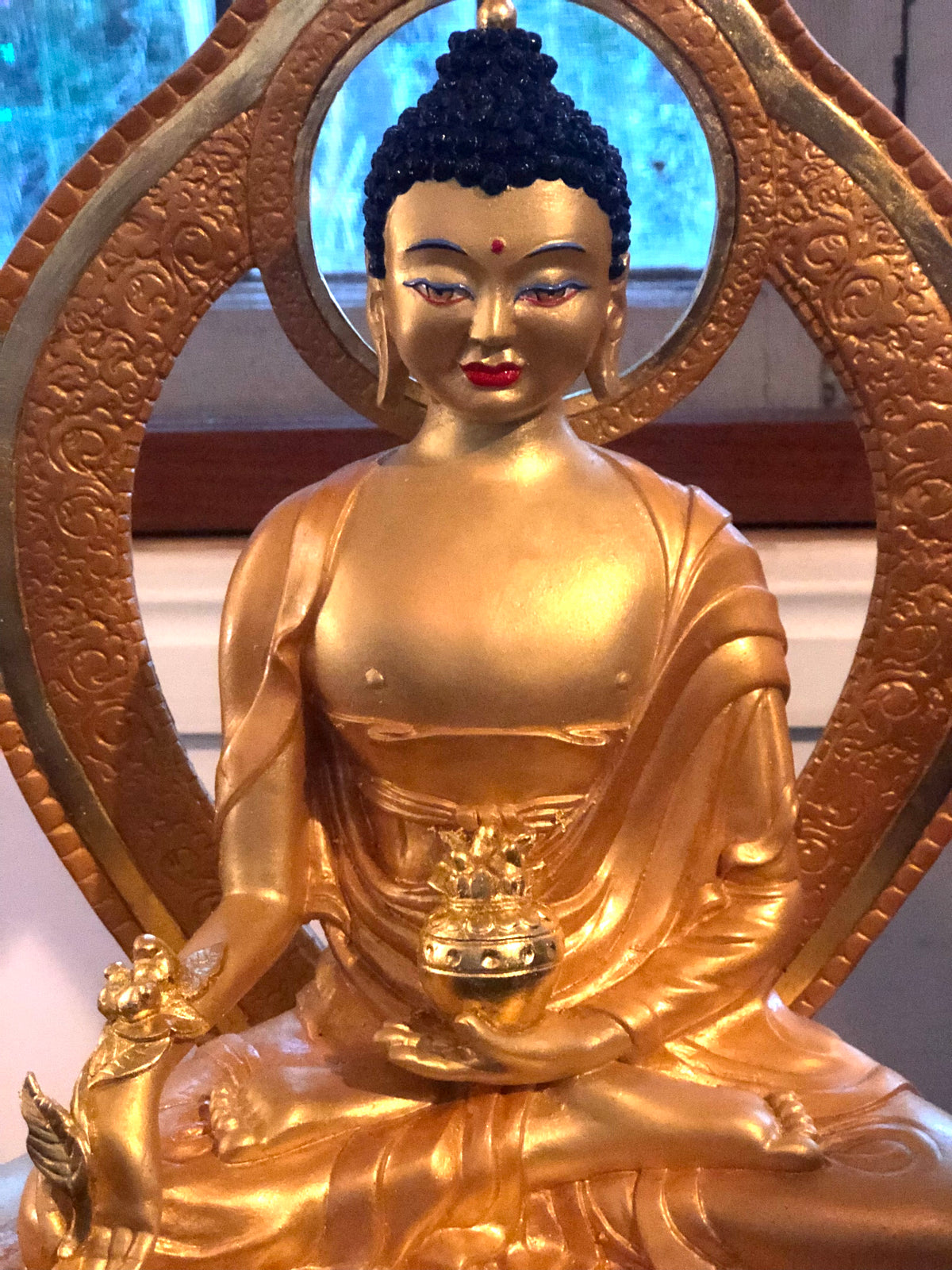Detailed close up of golden medicine Buddha statue
