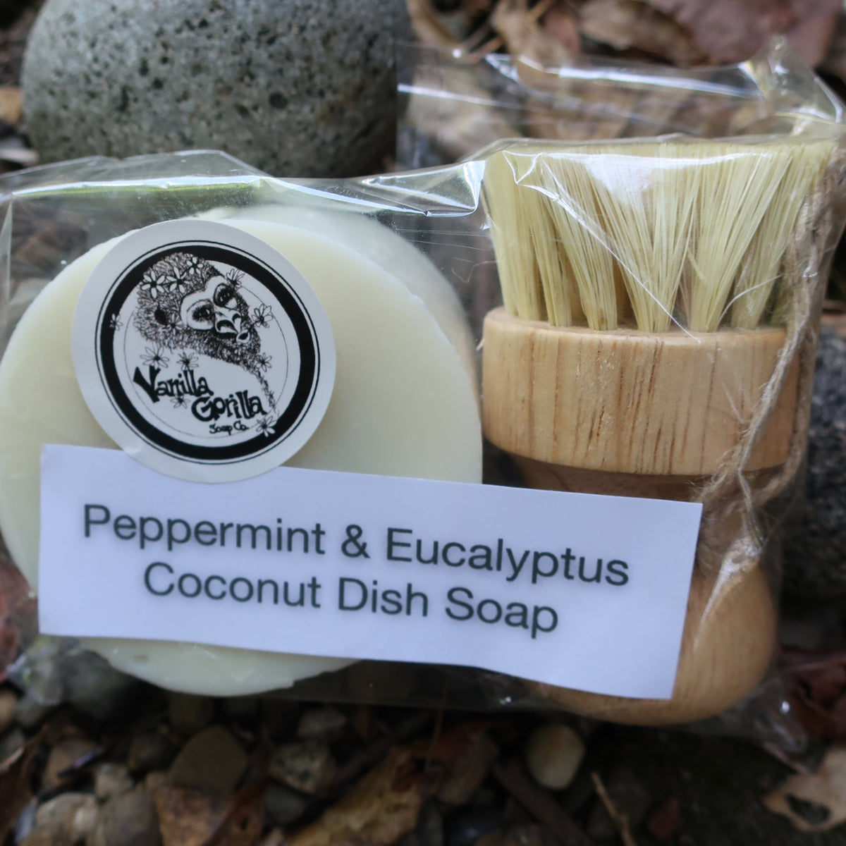 Peppermint & Eucalyptus Coconut Dish Soap in packaging with a brush on a natural background