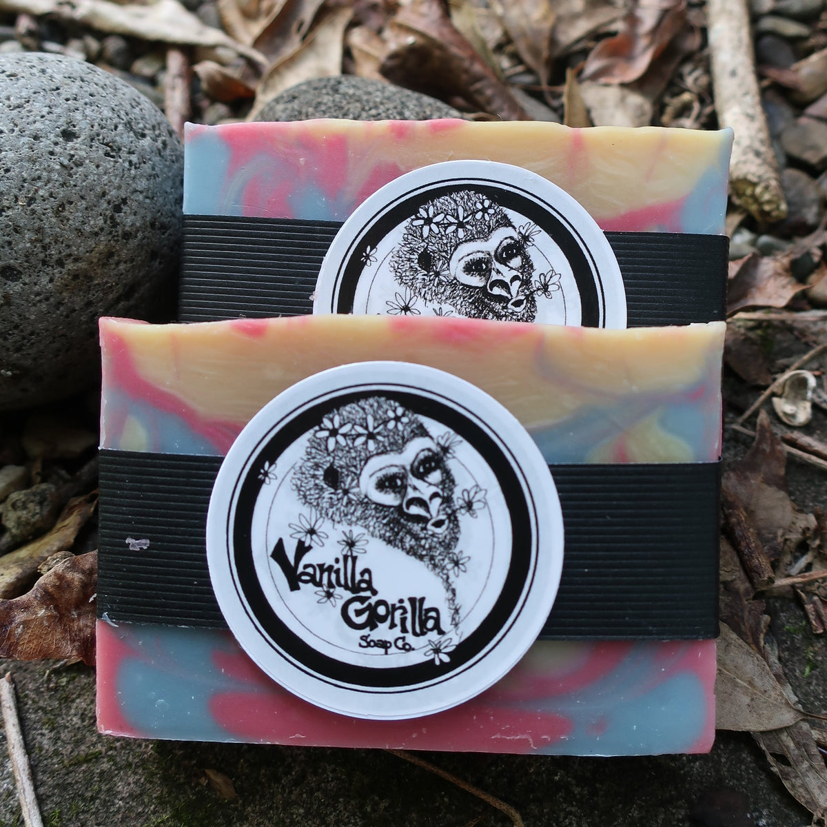 Two colorful love spell soap bars with a vanilla gorilla logo on a natural background