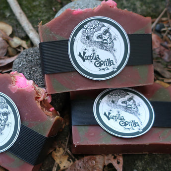 Three bars of sweet candy apple bar soap with 'Vanilla Gorilla ' branding on a leafy background