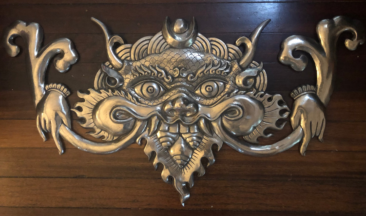 Polished bronze face of victory on a wooden background