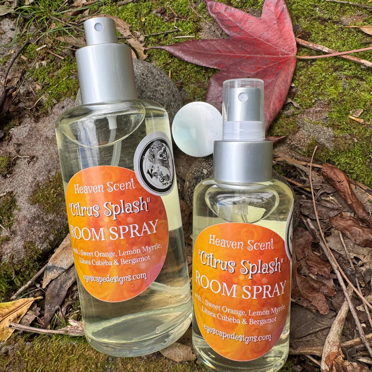 Two bottles of Heaven Scent Citrus Splash Room Spray on a natural background with leaves.