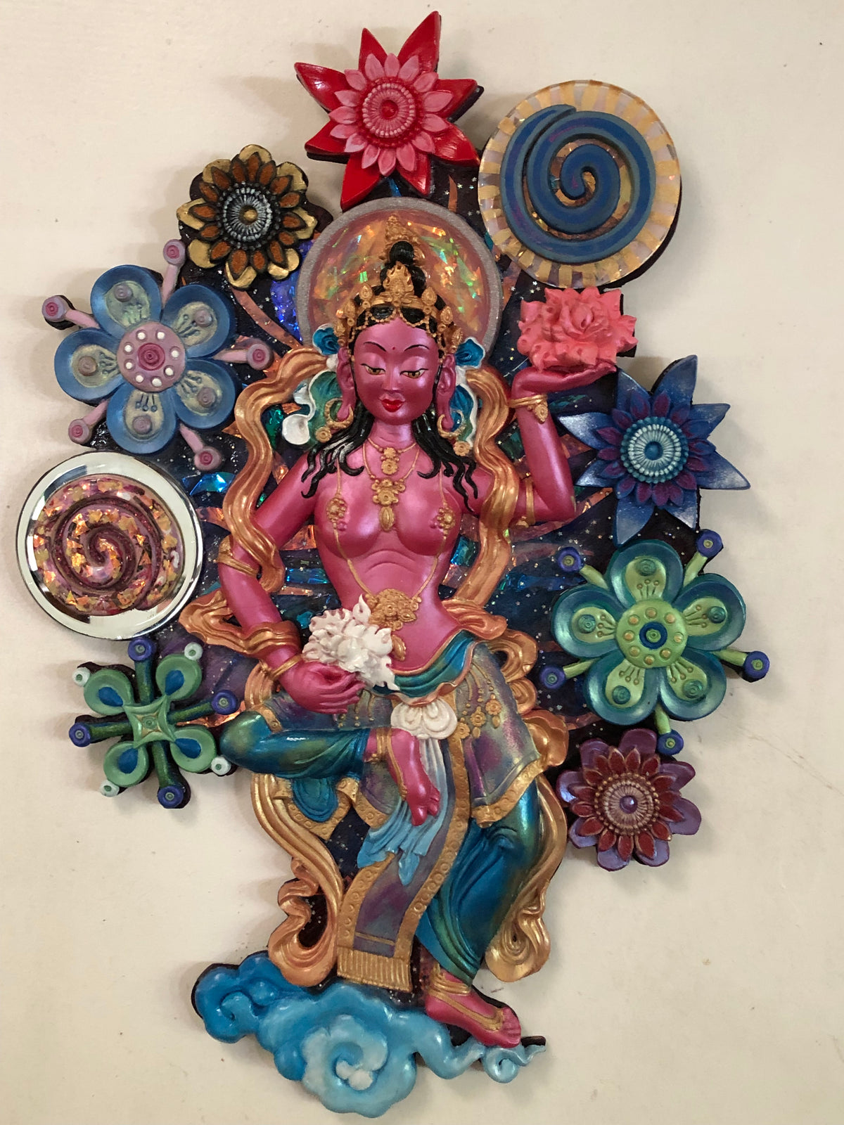 3d wall art featuring a pink offering goddess in a see of colourful flowers
