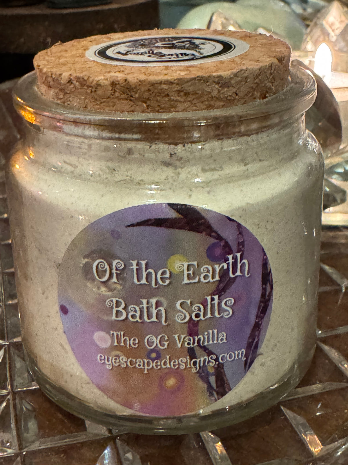 Jar of bath salts with a label on a reflective surface
