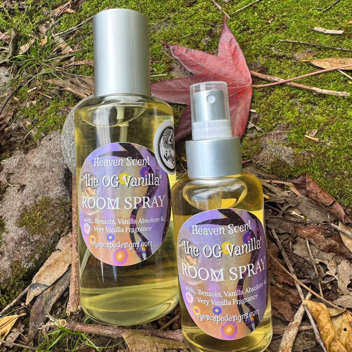 Two bottles of 'The OG Vanilla' room spray in glass bottles on a natural background with leaves and moss.
