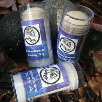 Three natural  bush baby deodorant sticks with blue vanilla gorilla labels on a natural background