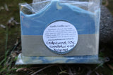 Bar of soap with a label on a grassy background