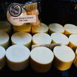 Multiple bars of soap with a lemon myrtle and coconut dish soap bar in the background.
