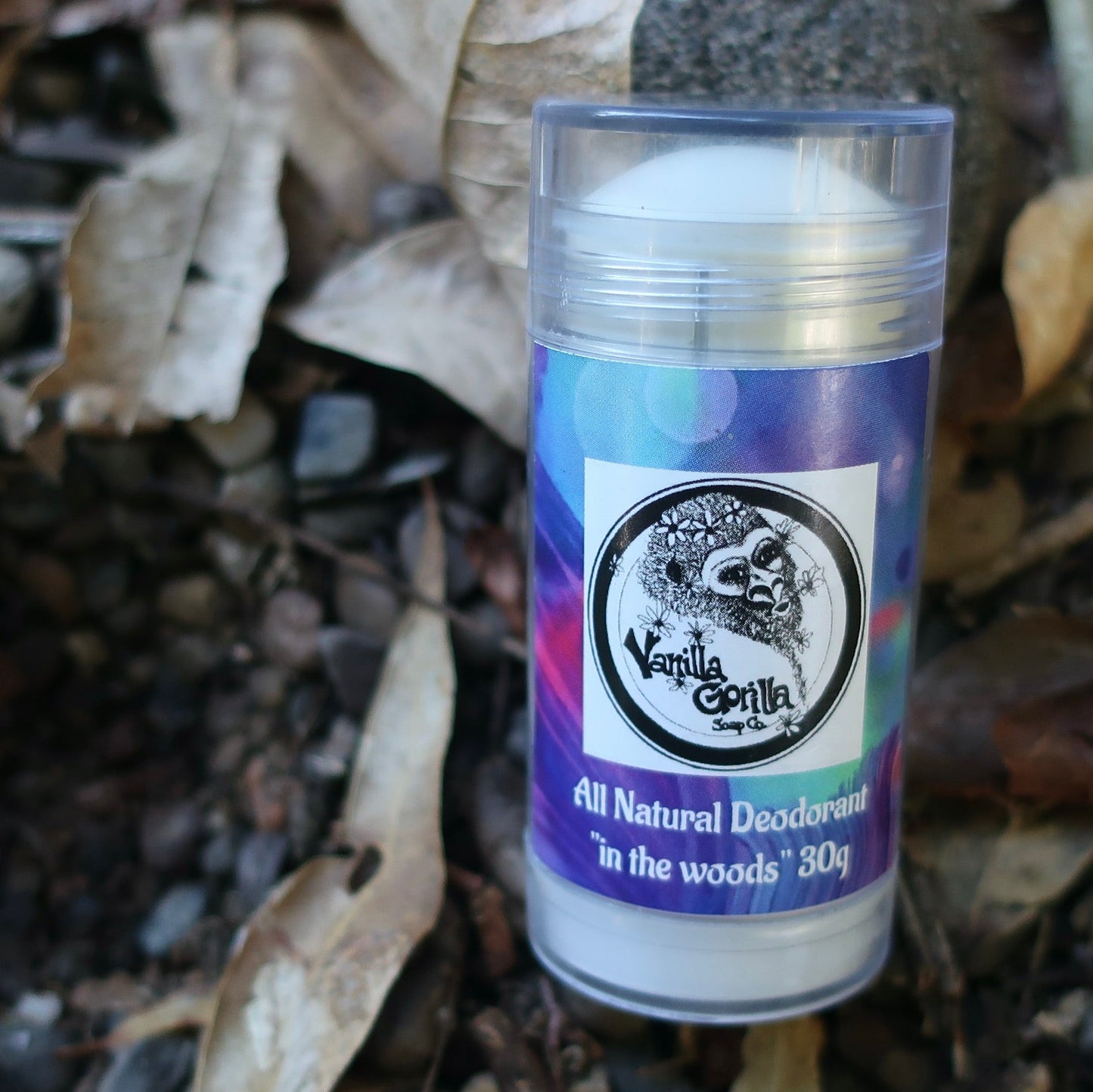 All natural  In the Woods Violet edition deodorant stick with a label on a natural background