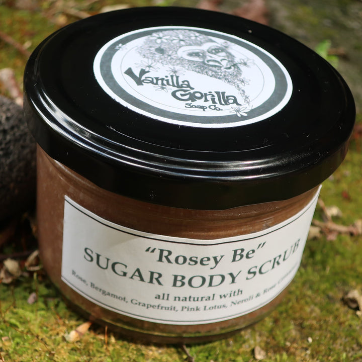 Jar of 'Rosey Be' Sugar Body Scrub with a black lid on a grassy background