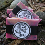 Two pink/lavender soap bars with a vanilla gorilla  logo on a natural background