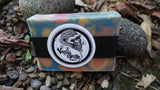 Colorful orange swirl soap bar with a vanilla gorilla label on a natural stone background