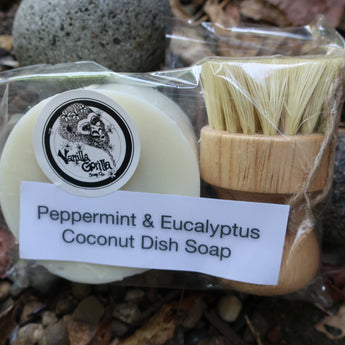 Peppermint & Eucalyptus Coconut Dish Soap in packaging with a brush on a natural background