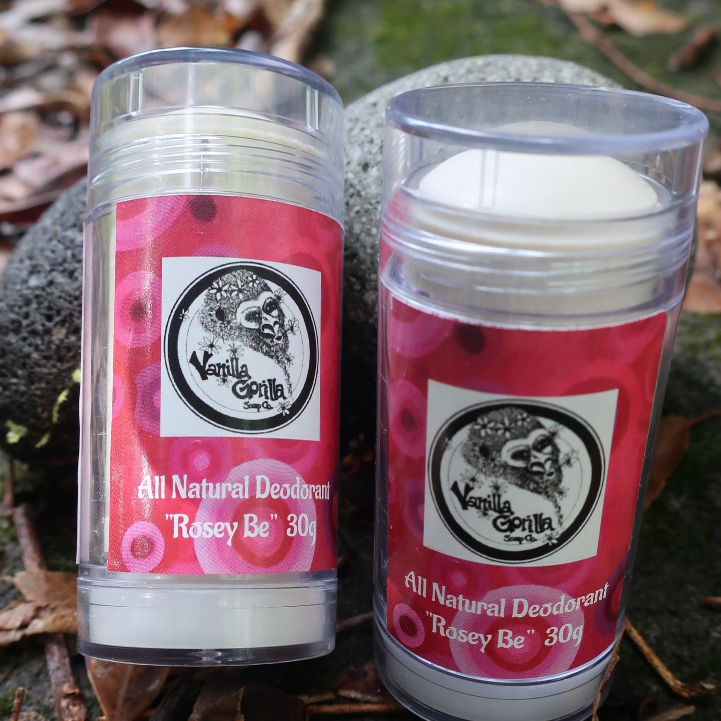 Two containers of Vanilla Gorilla All Natural Deodorant labeled 'Rosey Be' on a natural background.