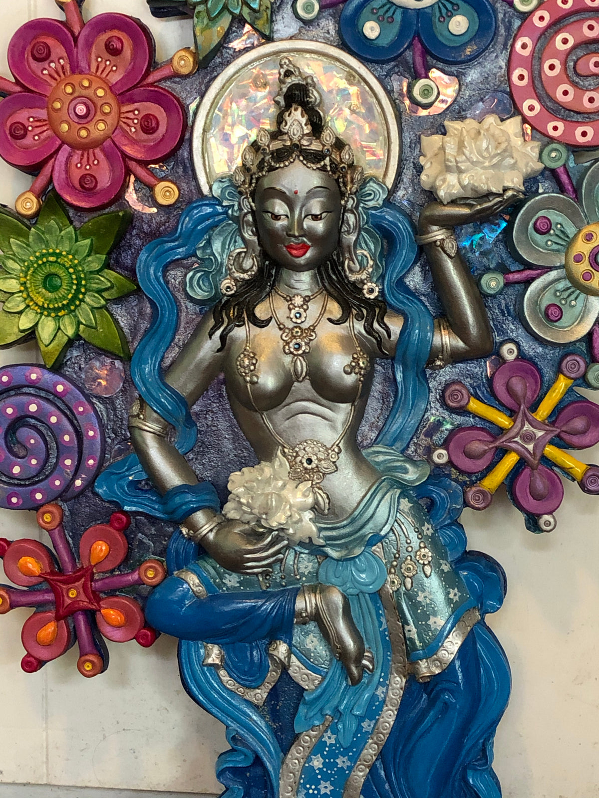 Colourful dakini surrounded be a garden of moonlflowers in 3 dimensional wall art
