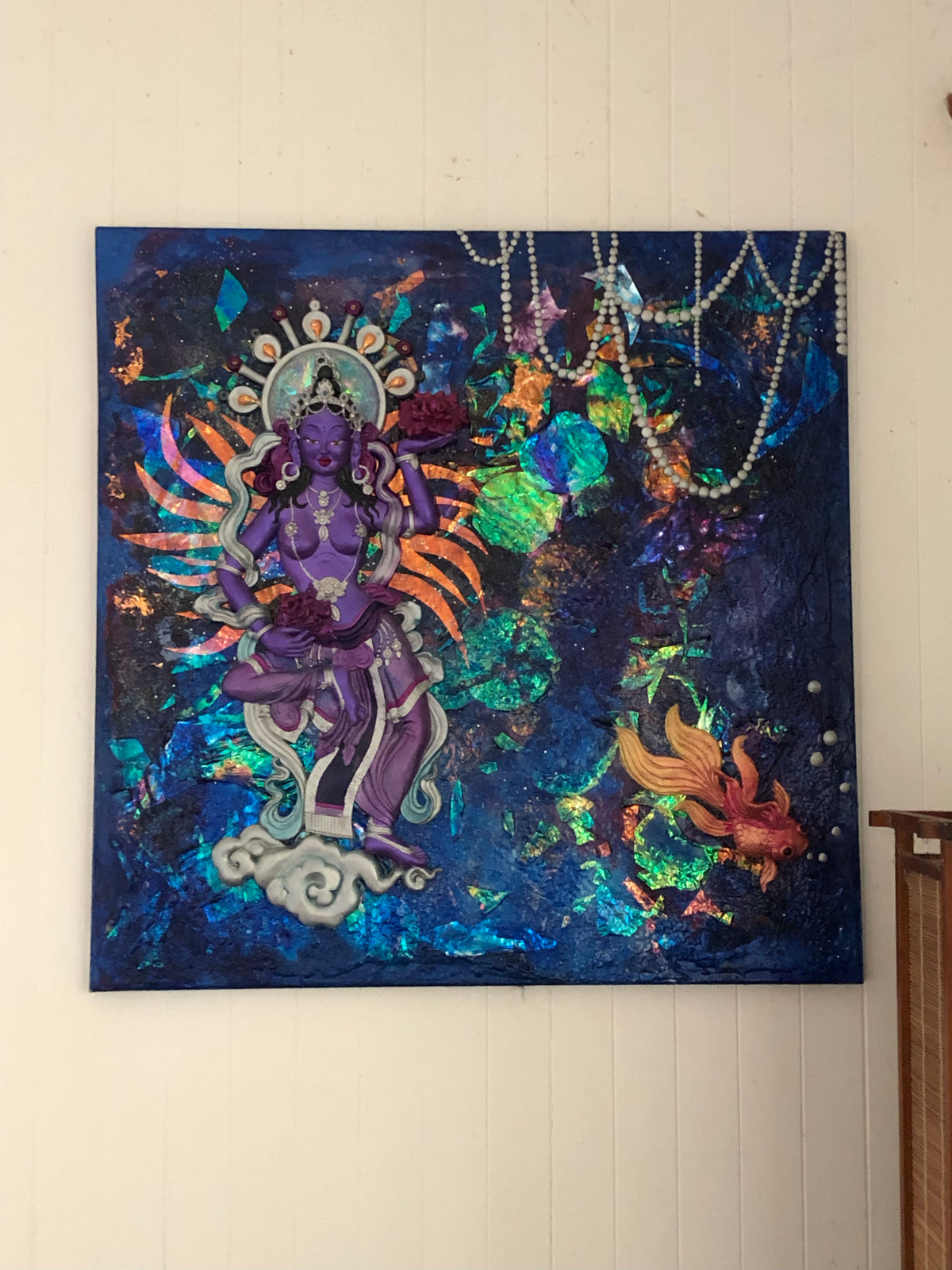 Square canvas with irridescent galactic goddess and gold fish swimming around in a night sky